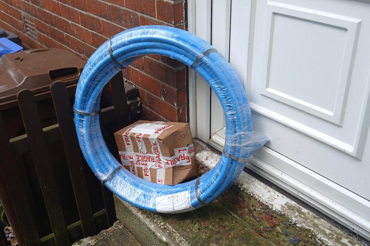 Customer Service: A battered parcel, covered in Fragile tape, on a doorstep