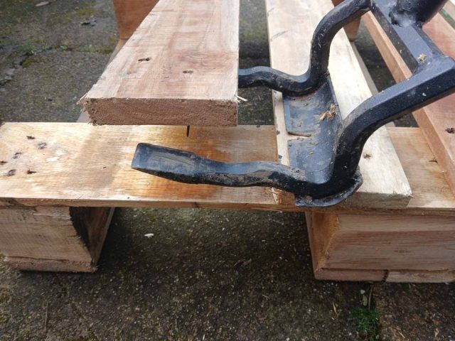 Using the pallet buster to dismantle the pallet top.