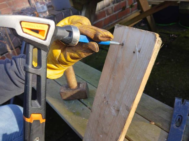 Using a nail punch to remove a sheered nail.