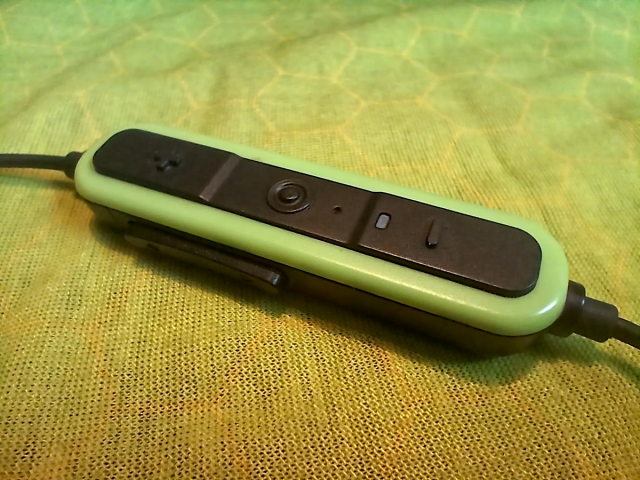 A close-up of the control pack for the ISOtunes Pro Aware 2.0 Earphones.