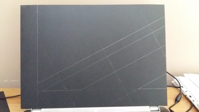 An image of a rectangular piece of black card, showing a quarter of the design for the UK Union Flag.