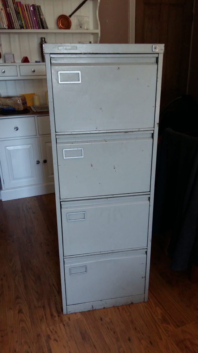 Image of a four-drawer, grey filing cabinet.
