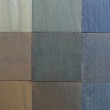 Image shows wooden squares of differing species, with the application of Oak Burnish.