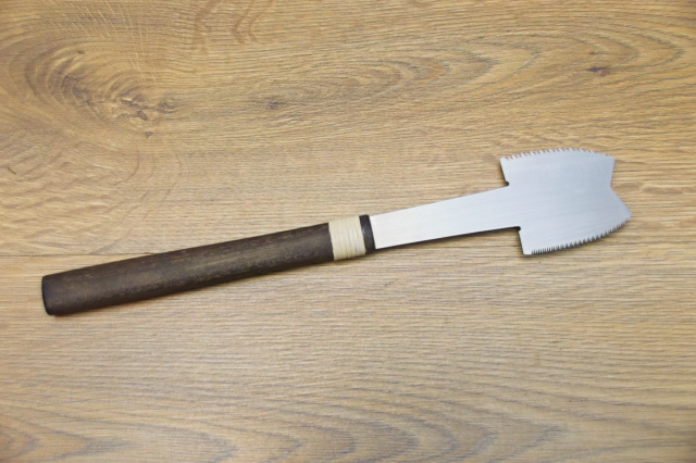 An Azebiki-nokogiri Japanese Saw, shown on a wooden background.