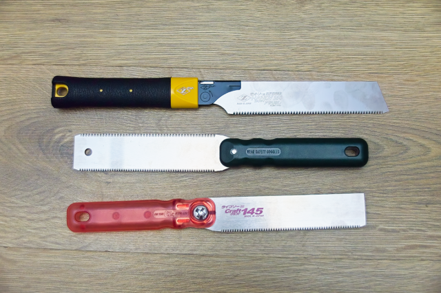 Three Kugihiki-nokogiri Japanese Saws, shown on a wooden background.